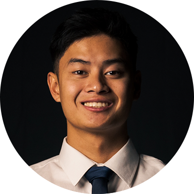 cole-headshot A person wearing a white shirt and dark tie, smiling against a dark background.